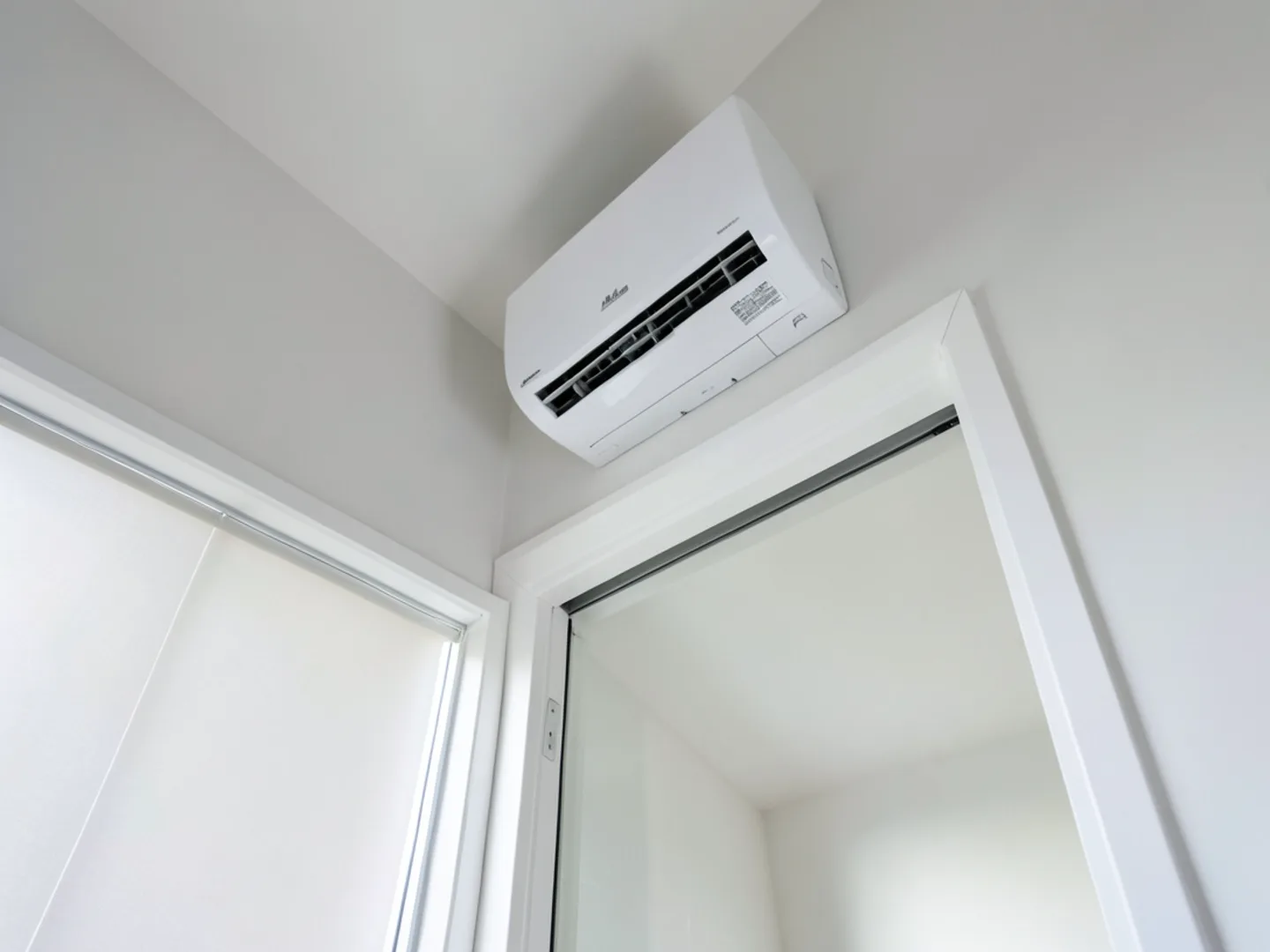Ductless heat pump wall head mounted above headboard in Cupertino master bedroom suite