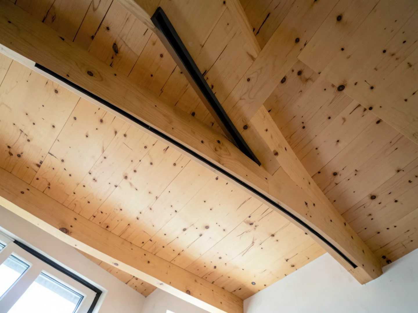 Discreet architectural linear slot diffuser integrated seamlessly into high vaulted wood ceiling